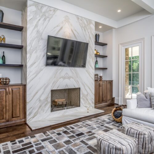 "Modern Living Room with Fireplace, TV, French Doors & White Sofa "