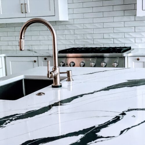 Black and White quartz Kitchen Countertop with Rose Gold Faucet