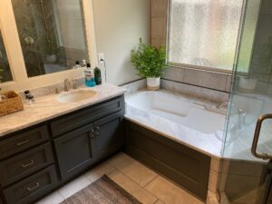 "Modern Bathroom with Charcoal Vanity, Granite Countertop & Bathtub "