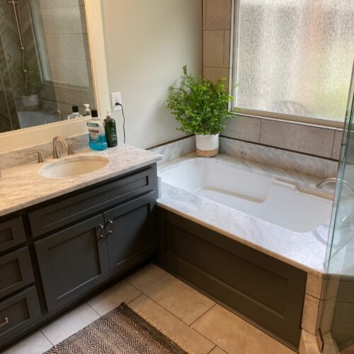 "Modern Bathroom with Charcoal Vanity, Granite Countertop & Bathtub "