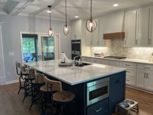 Modern Kitchen with Gray Cabinets, Quartz Countertops, Navy Island, Pendant Lights & Patterned Tile