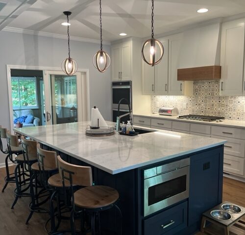 Modern Kitchen with Gray Cabinets, Quartz Countertops, Navy Island, Pendant Lights & Patterned Tile