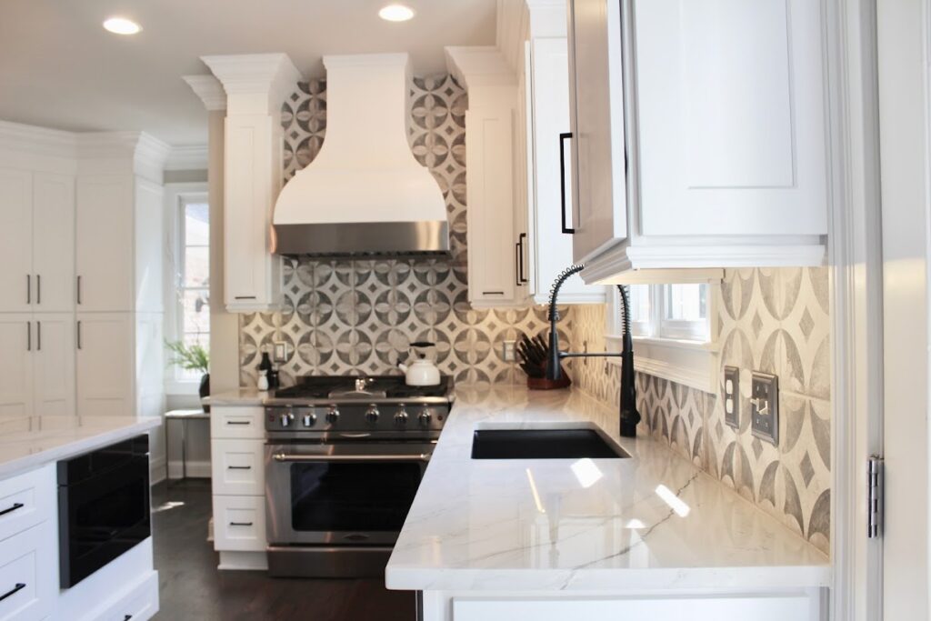 "Kitchen Corner with White Cabinets, Quartzite Countertops & Geometric Backsplash "