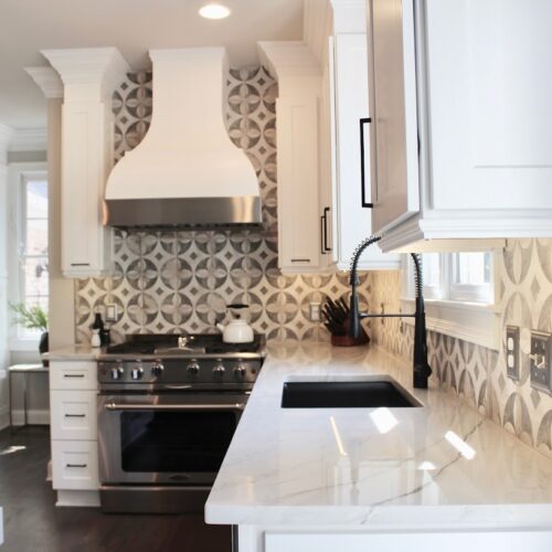 "Kitchen Corner with White Cabinets, Quartzite Countertops & Geometric Backsplash "