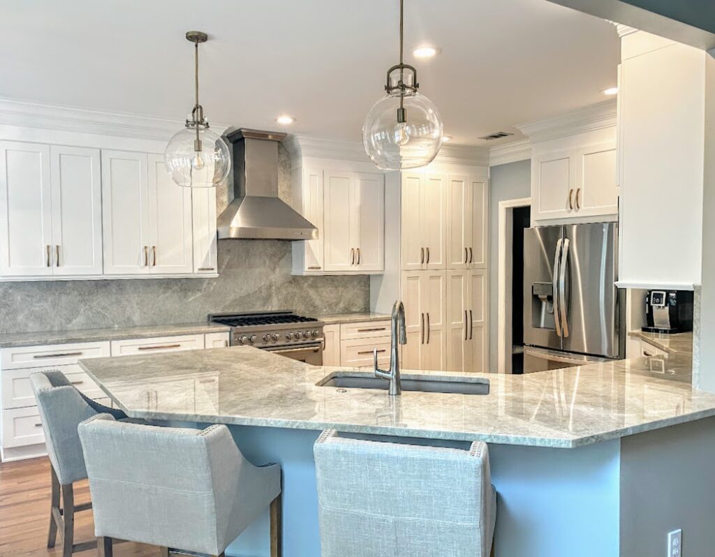 Spacious Kitchen with White Cabinets, Quartzite Counters & Blue Island