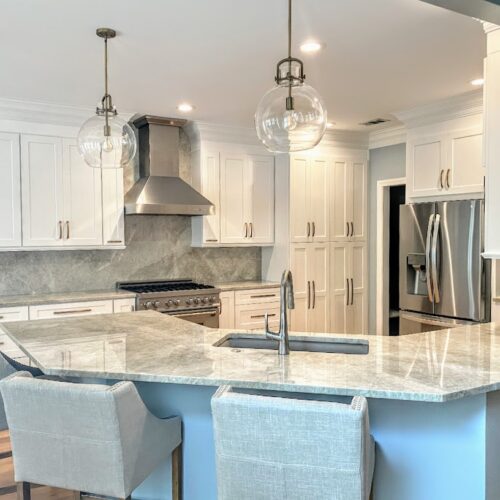 Spacious Kitchen with White Cabinets, Quartzite Counters & Blue Island