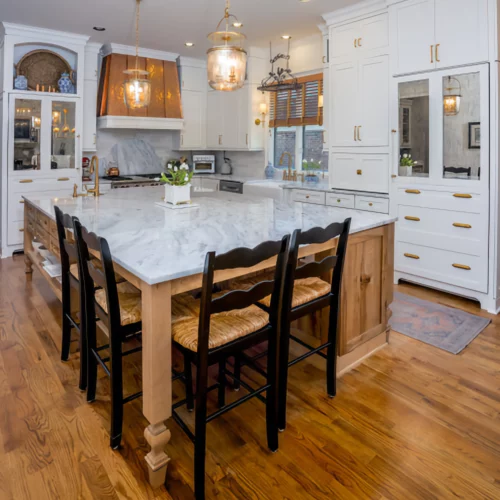 "Luxury Kitchen with White Cabinets, Granite Island & Gold Accents "