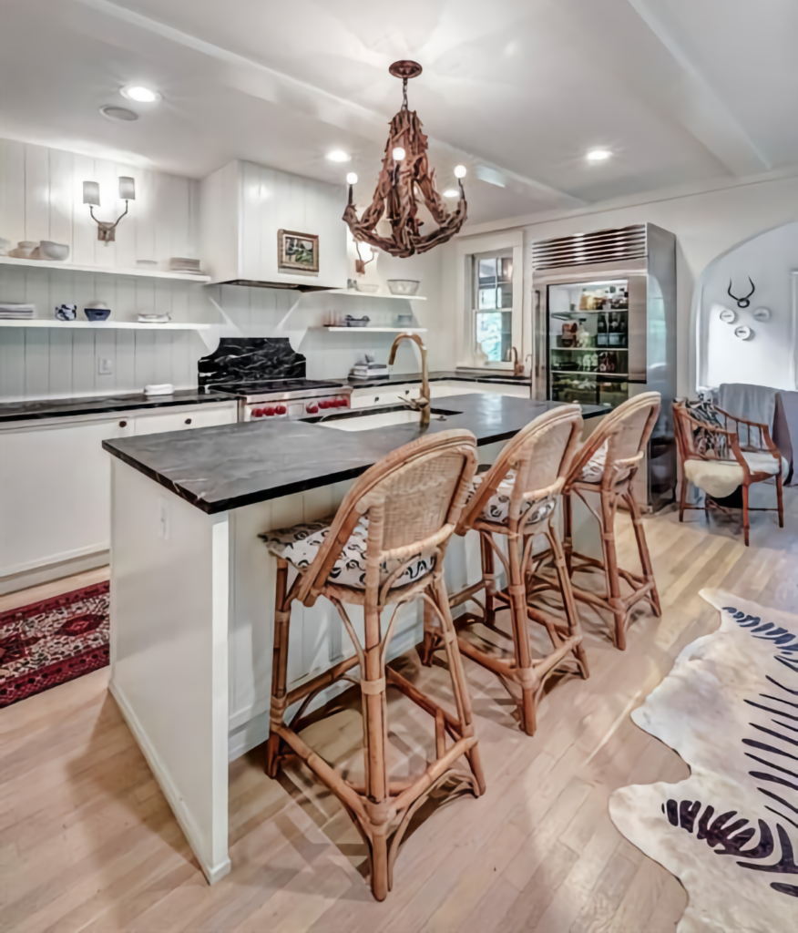 Coastal Kitchen with White Cabinets, Soapstone Island & Wicker Bar Stools