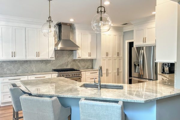 Spacious Kitchen with White Cabinets, Quartzite Counters & Blue Island