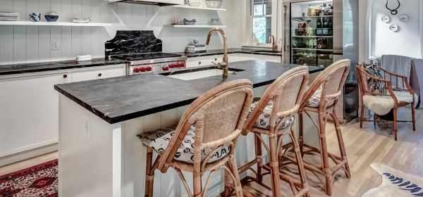 Coastal Kitchen with White Cabinets, Soapstone Island & Wicker Bar Stools