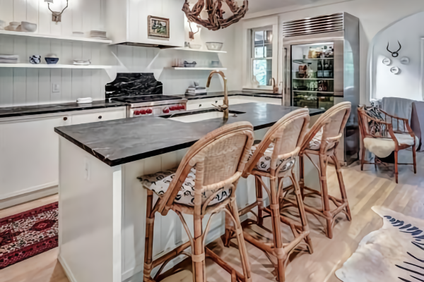 Coastal Kitchen with White Cabinets, Soapstone Island & Wicker Bar Stools